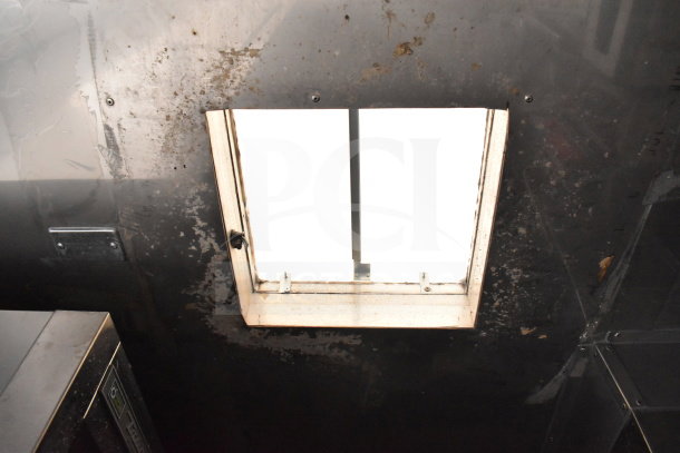 Interior view of 2021 Texino cooking trailer with ceiling vent and stainless surfaces, showcasing operational quality.