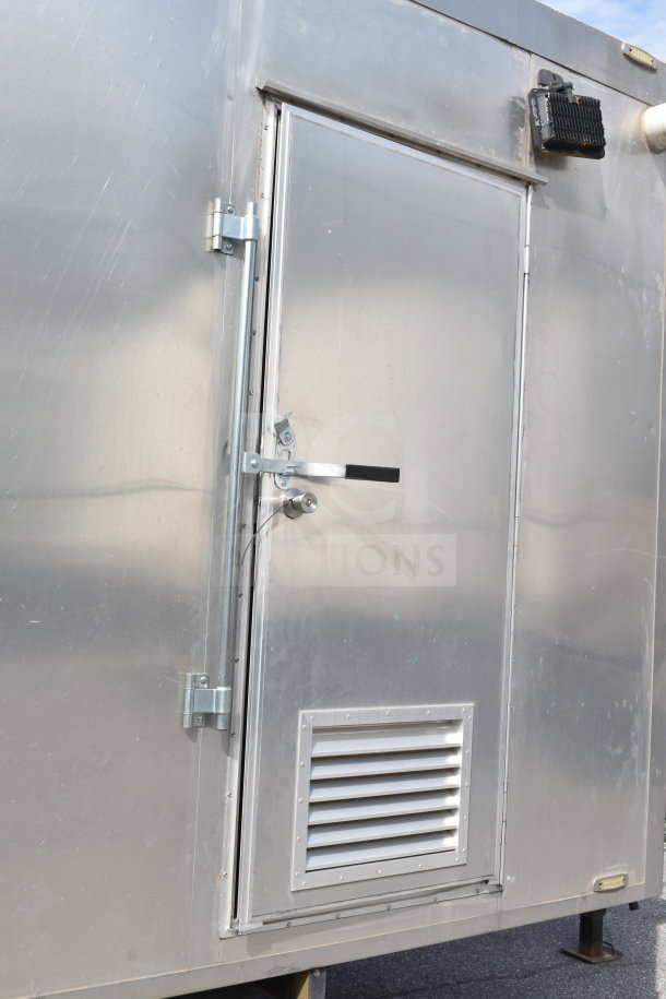 2021 Texino 28ft triple-axle cooking trailer exterior, featuring a secured entry door with vent.