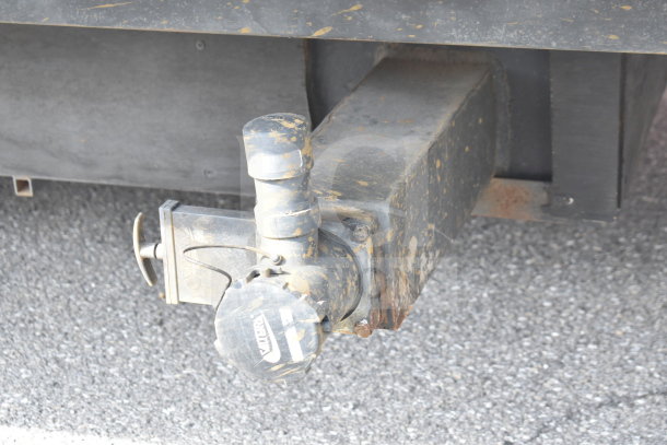 Hitch detail of Texino cooking trailer, showing a weathered and sturdy design with a visible brand marking.