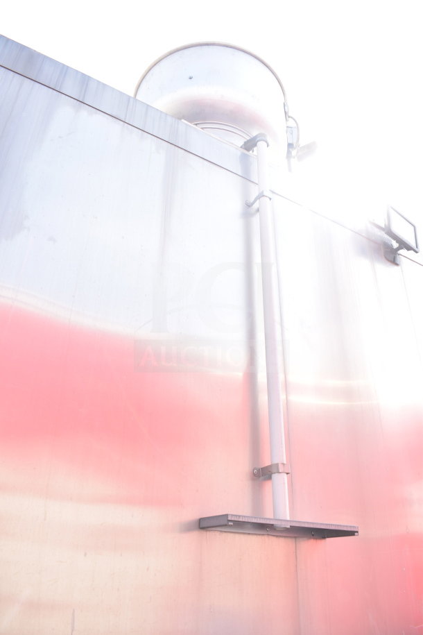 Exterior view of a 2021 Texino 28ft cooking trailer, showing stainless steel surface and ventilation feature.