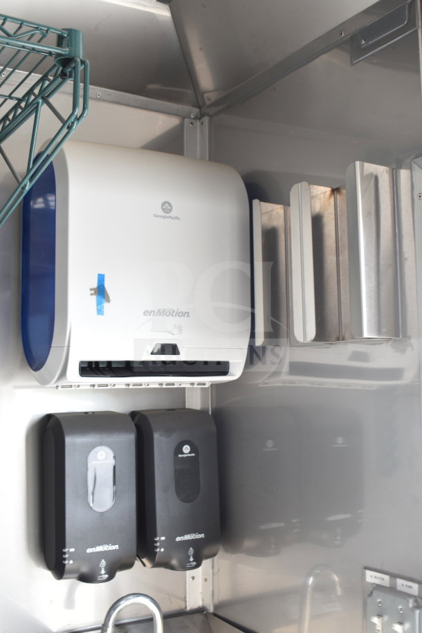 Interior of 2021 Texino cooking trailer featuring a Georgia-Pacific enMotion paper towel dispenser and two enMotion soap dispensers.