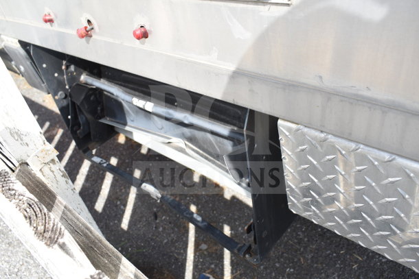 Rear undercarriage of 2021 Texino 28ft Triple-Axle Cooking Trailer, showing chassis and diamond plate detail, VIN visible.