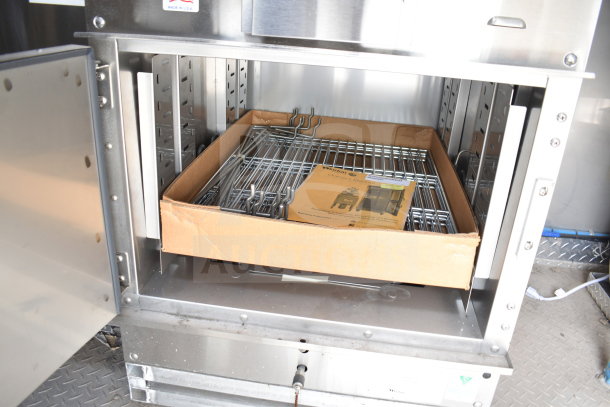 Industrial cooking trailer interior with stainless steel shelving and Winston CVap holding unit packaging, showcasing new equipment condition.
