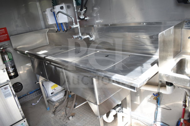 Texino 2021 Popeyes-configured cooking trailer interior, featuring stainless steel sinks and fittings, pristine condition.