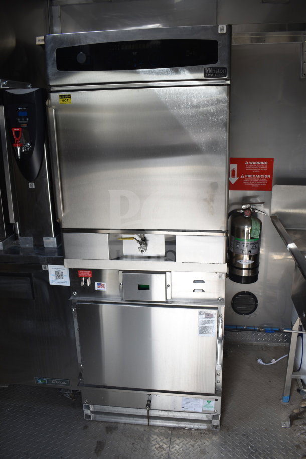 Cooking trailer interior with a Winston CVap Holding unit. Features stainless steel exterior, warning labels, and other kitchen equipment.