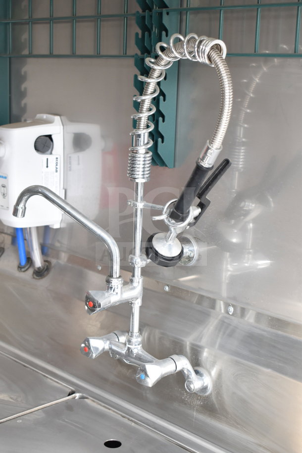 Commercial sink faucet with flexible sprayer in 2021 Texino cooking trailer. Stainless steel finish, clean and functional.