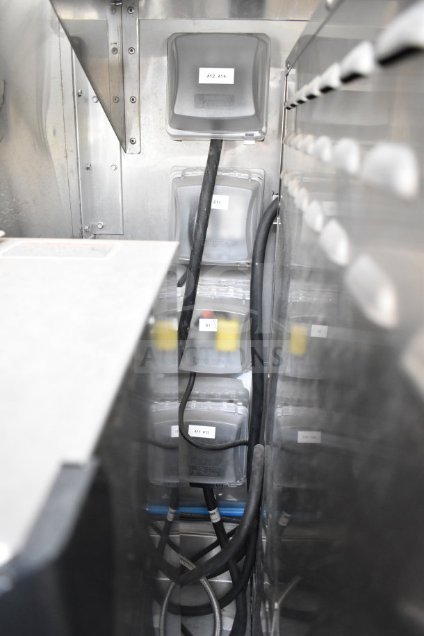 Interior view of 2021 Texino cooking trailer showing wiring and labeled compartments, indicating organized utility setup.