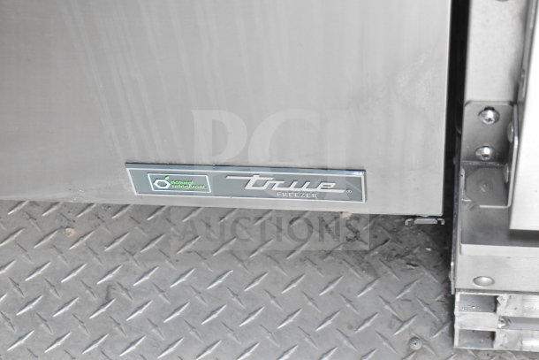 True freezer label on a diamond plate floor of a 2021 Texino cooking trailer, featuring True refrigeration suite.