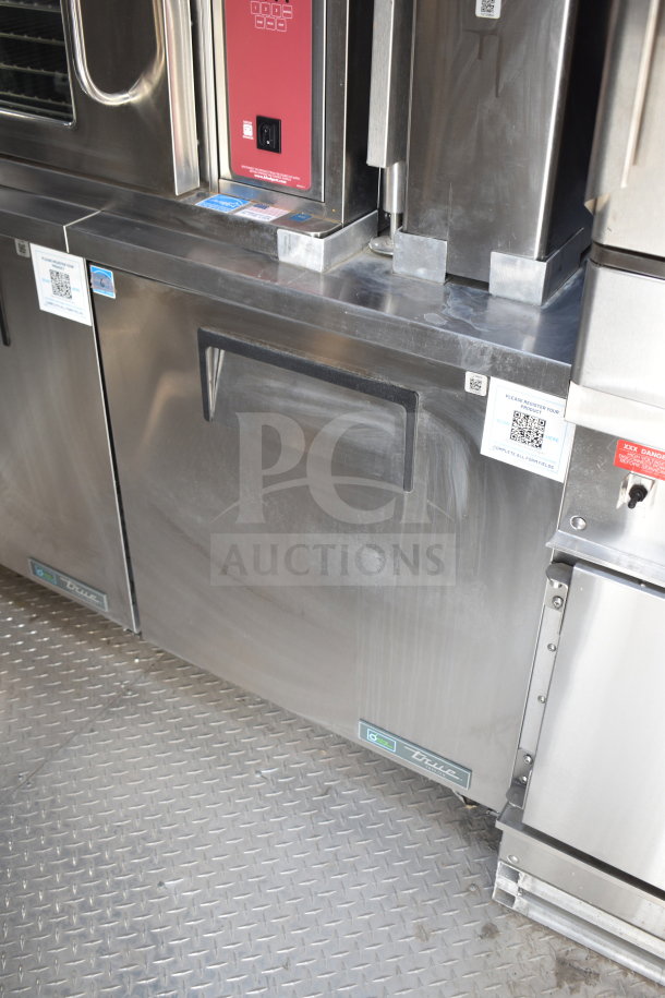 Texino 28ft cooking trailer interior, featuring a True refrigeration unit and Ultrafryer Ultrastat23 control panel.