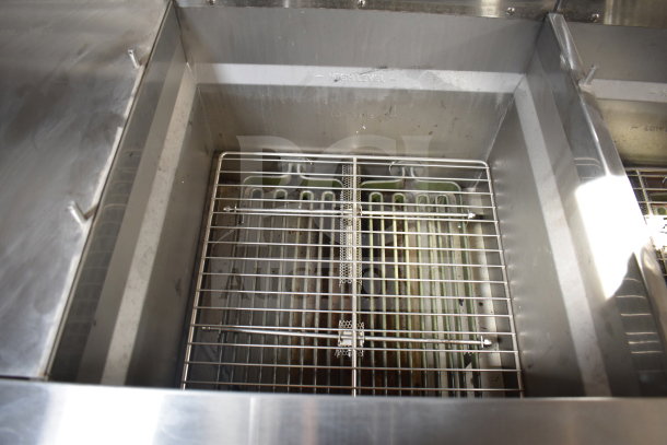 Interior of Ultrafryer Ultrastat23 4-bay fryer in Texino 2021 cooking trailer, showcasing clean fryer baskets.