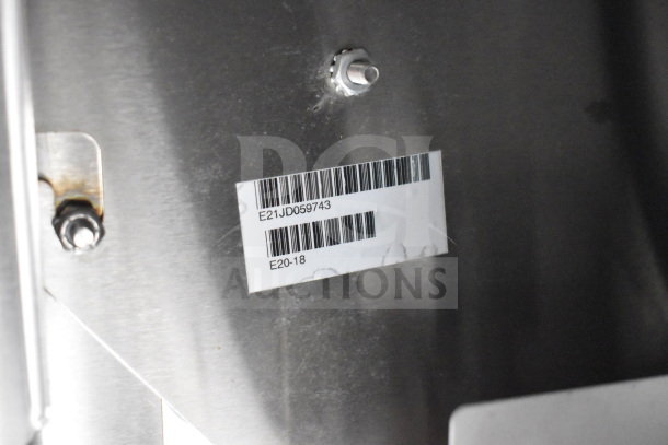 Barcode and text labels on Texino 2021 cooking trailer interior. Model E20-18, ID E21JD059743.