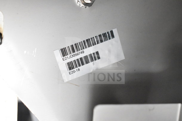Barcode label on the Texino 2021 cooking trailer, showing serial number E21JD059749 and code E20-18.