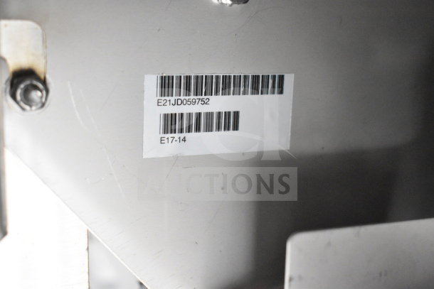 Barcode label on Texino cooking trailer equipment, showing code E21JD059752 and other reference numbers.