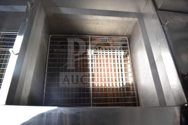 Ultrafryer Ultrastat23 fryer bay inside Texino 28ft cooking trailer; features stainless steel interior and wire rack.