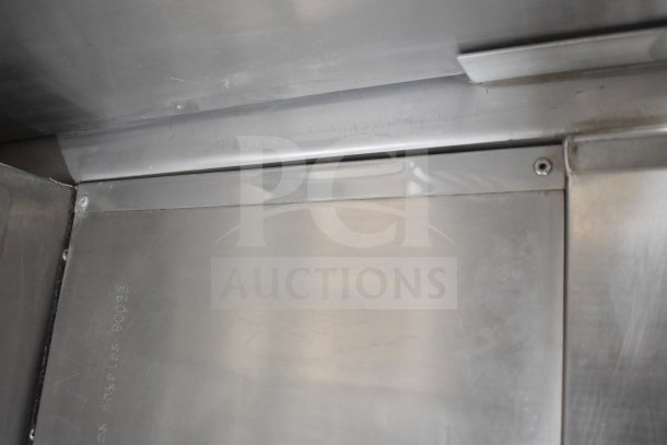 Interior view of a 2021 Texino cooking trailer, showcasing stainless steel finish and construction details.