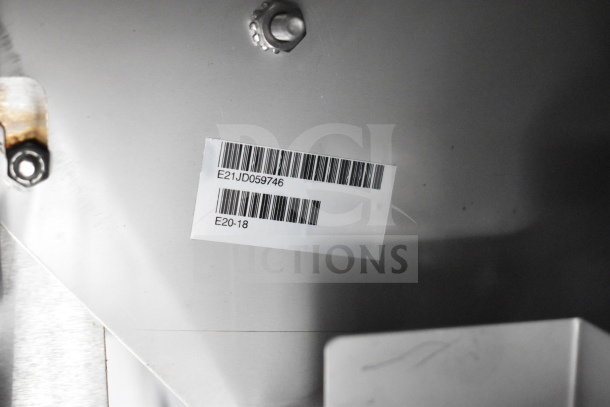 Barcode sticker with numbers E21JD059746 and E20-18 on Texino cooking trailer equipment.