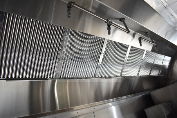 Interior view of 2021 Texino cooking trailer showing a CaptiveAire hood and suppression system, stainless steel finish.