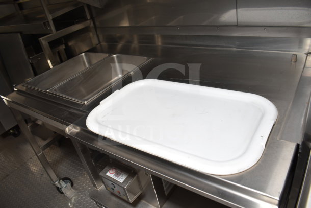 Texino 28ft cooking trailer with stainless steel prep station, dual sinks, and equipment storage. New, 2021 model.