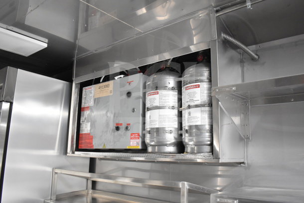 2021 Texino 28ft cooking trailer with CaptiveAire hood and suppression, featuring two tanks and control panel.