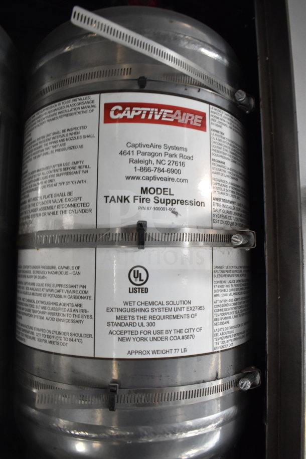 CaptiveAire Tank Fire Suppression label on a cooking trailer, detailing model info and safety standards.