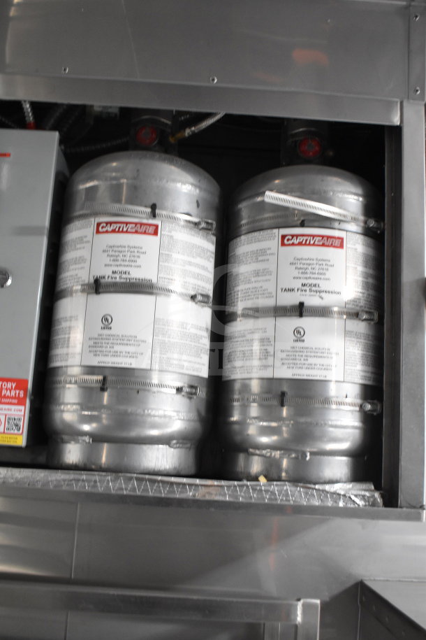 CaptiveAire fire suppression tanks inside a cooking trailer. Labels detail model and safety info for the 2021 Texino trailer.