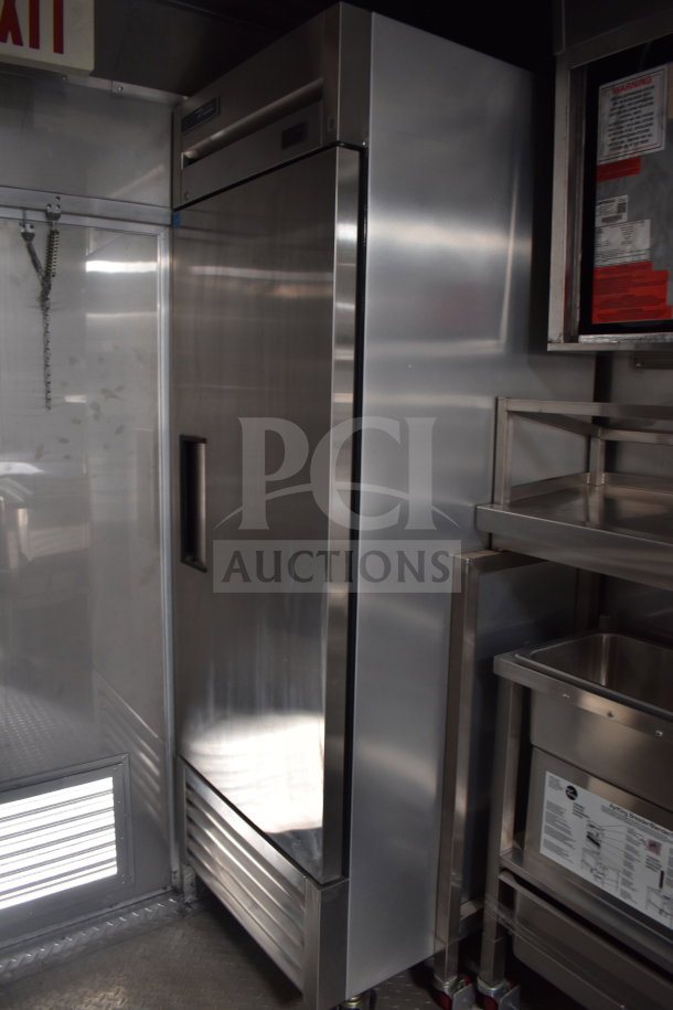2021 Texino cooking trailer interior showing True refrigeration unit and stainless steel storage.