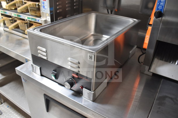 Stainless steel heated well in Texino cooking trailer, featuring temperature controls and Ultrafryer Ultrastat23 equipment.