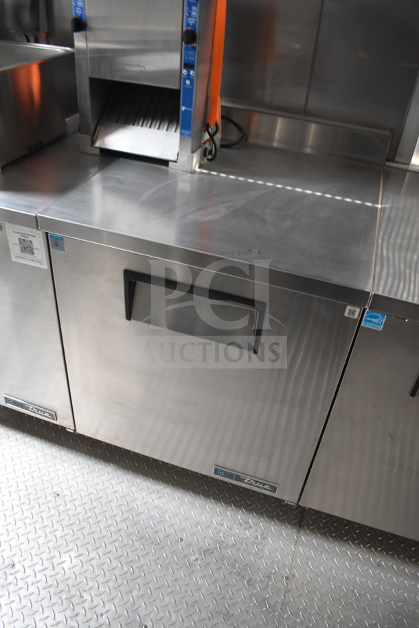 2021 Texino cooking trailer interior; stainless steel equipment includes True refrigeration, featuring robust surfaces.