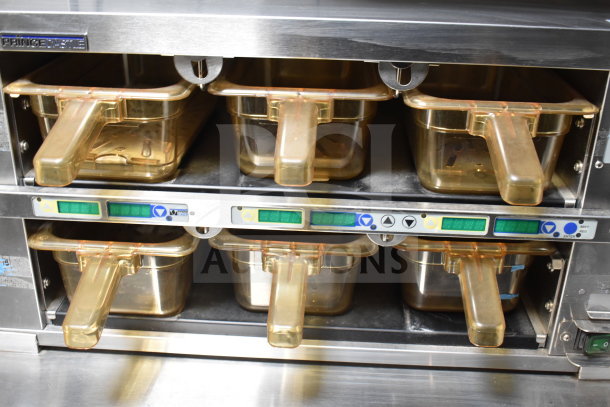 Stainless steel cooking station with Prince Castle containers, digital controls, and handles, part of a 2021 Texino trailer.