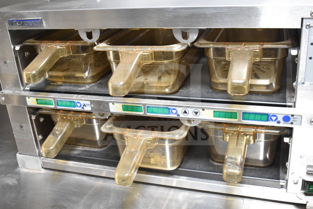 Texino cooking trailer's Prince Castle warming unit with six transparent trays, control panel, and sturdy metal frame.