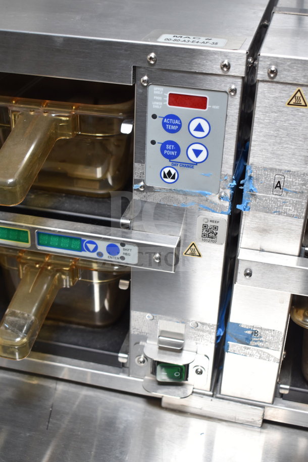 Close-up of a control panel on a 2021 Texino cooking trailer showing temperature settings. Clear plastic containers nearby.