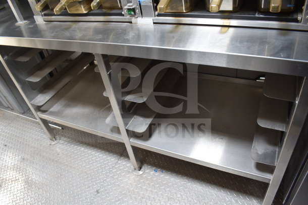 Stainless steel interior of 2021 Texino cooking trailer with shelving. Equipped with Ultrafryer Ultrastat23.