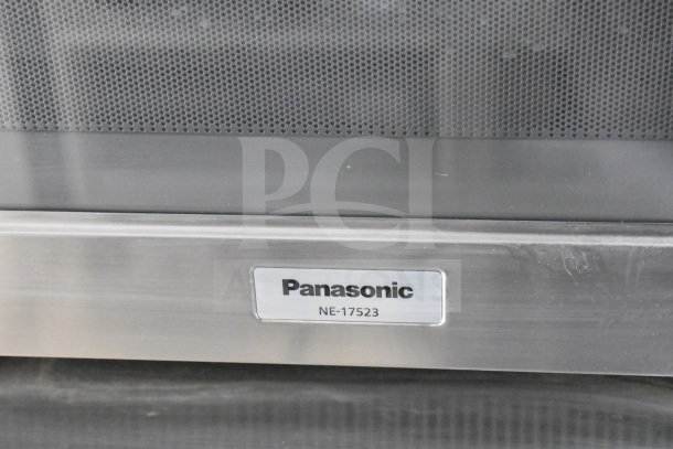 Panasonic NE-17523 microwave detail with mesh vent and metal finish, displaying model number label.