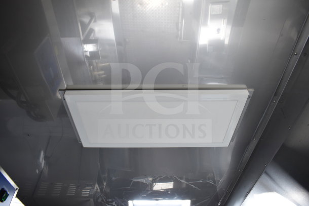 Interior view of a 2021 Texino cooking trailer showing a ceiling-mounted light fixture. Stainless steel surfaces visible.