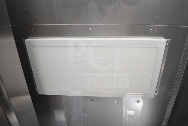 Texino Popeyes-configured cooking trailer interior with stainless steel wall, featuring a mounted light panel.