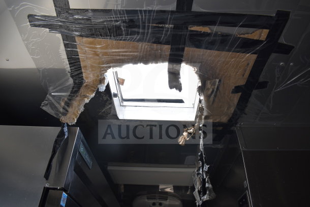 Damaged interior roof of 2021 Texino cooking trailer showing exposed insulation around repaired skylight.