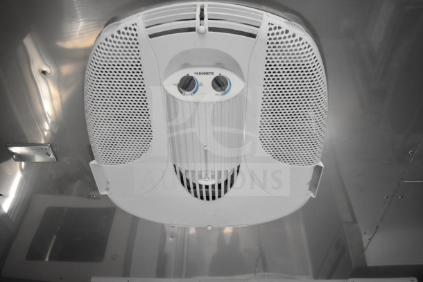 Ceiling-mounted Dometic control unit in Texino 28ft cooking trailer with fan and AC settings.