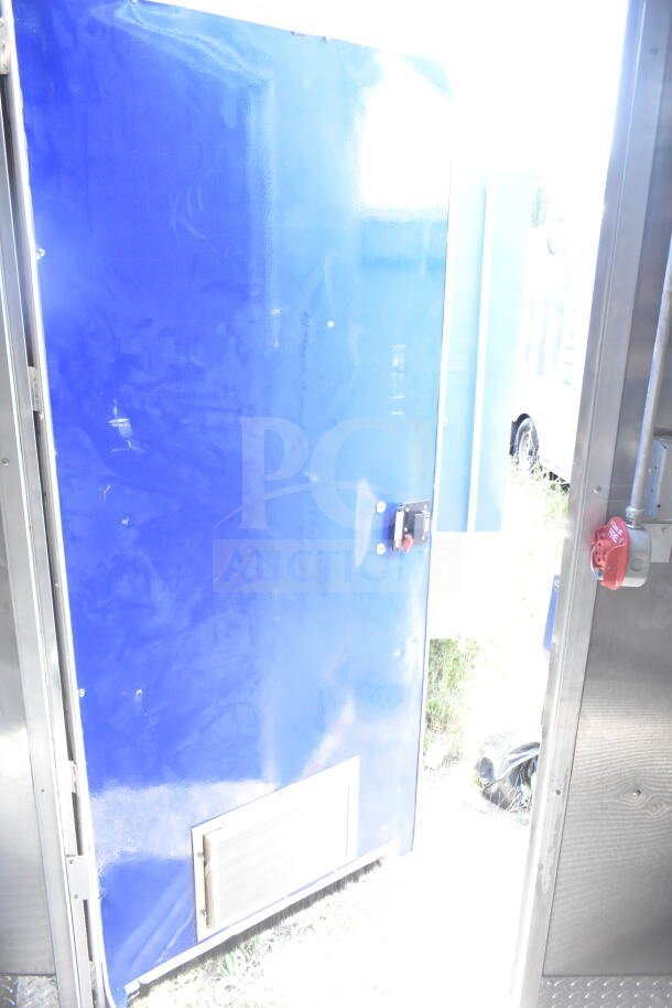 Rock Solid Cargo 8.5'x28' food trailer shell with CaptiveAire grease hood, blue exterior, ready for custom outfitting.