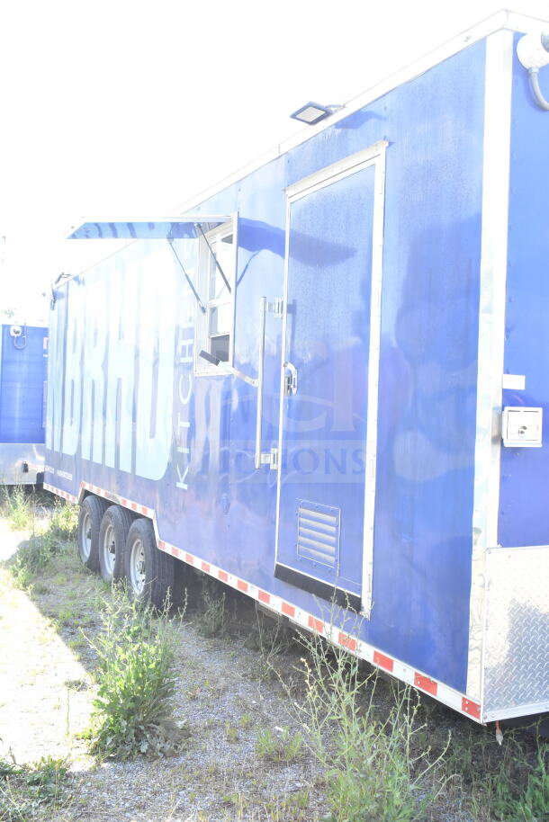 Rock Solid Cargo 8.5'x28' food trailer shell with CaptiveAire grease hood, blue exterior, ready for custom outfitting.