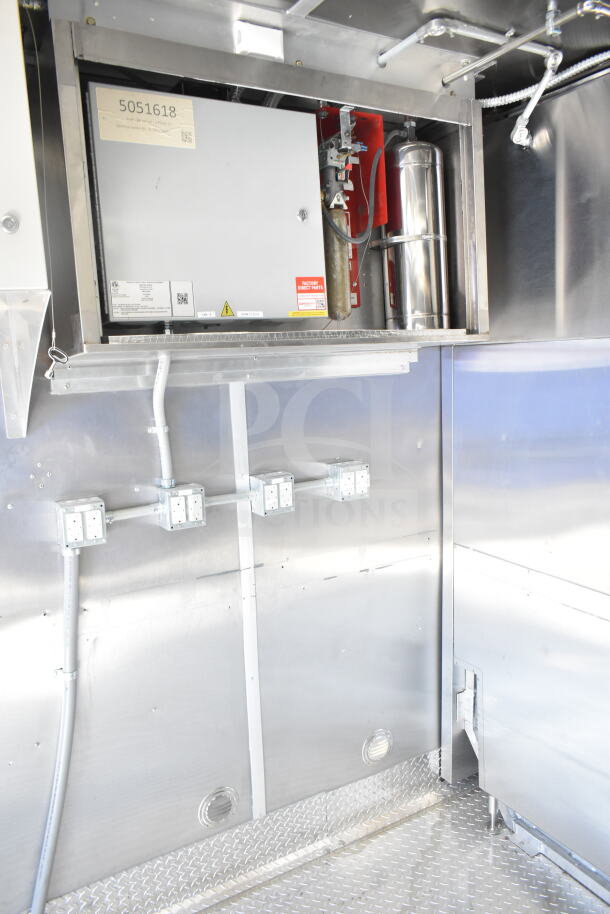 Rock Solid Cargo 8.5'x28' food trailer interior with CaptiveAire grease hood, electrical outlets, and diamond plate flooring.