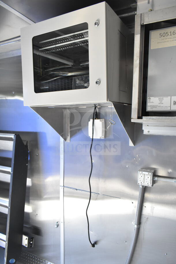 Rock Solid Cargo 8.5'x28' food trailer interior with CaptiveAire grease hood, electrical setup visible. Ready for outfitting.