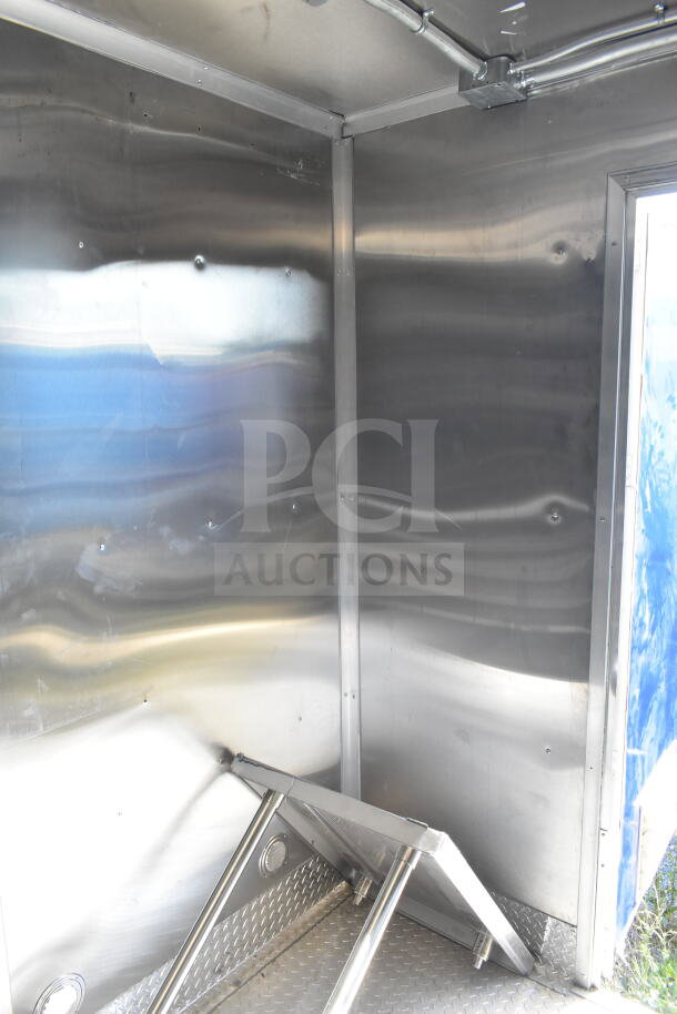 Rock Solid Cargo 8.5'x28' food trailer interior, featuring stainless walls and CaptiveAire grease hood. Ready for equipment.