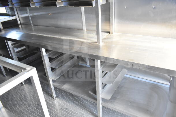 Rock Solid Cargo 8.5'x28' food trailer shell interior, featuring a CaptiveAire grease hood, ready to be outfitted.