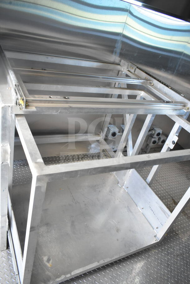 Rock Solid Cargo 8.5'x28' food trailer shell interior with CaptiveAire grease hood, ready for customization.