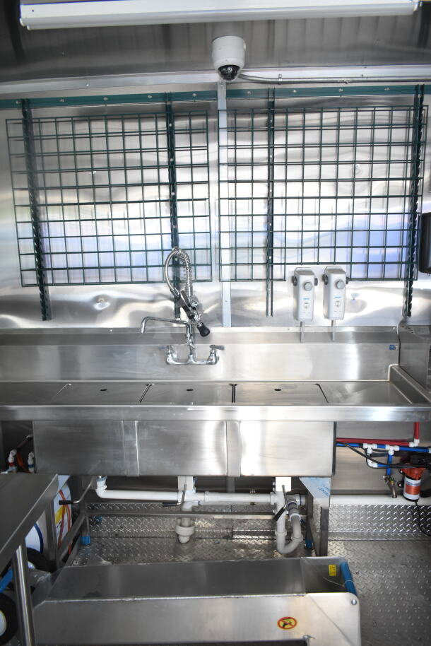 Rock Solid Cargo 8.5'x28' food trailer interior featuring stainless steel counters, sink, and CaptiveAire grease hood.