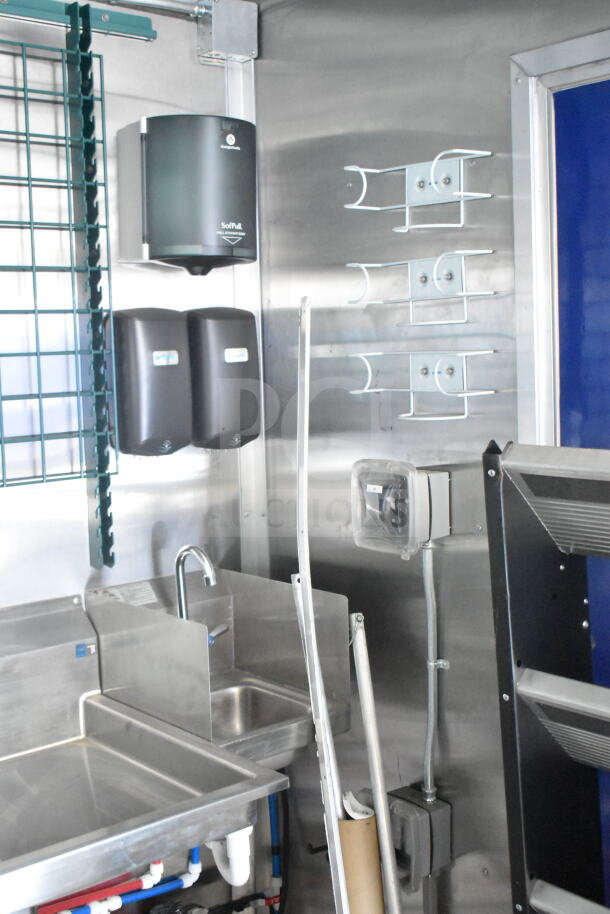 Rock Solid Cargo 8.5'x28' food trailer interior with CaptiveAire grease hood, stainless steel sink, and dispensers ready for customization.