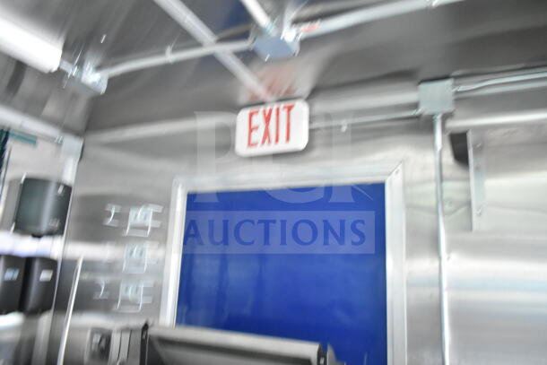 Rock Solid Cargo 8.5'x28' food trailer interior, featuring an installed CaptiveAire grease hood and metallic walls, ready for equipment.