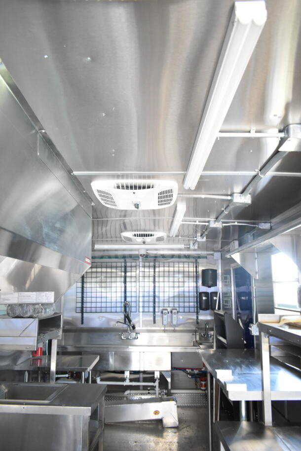 Rock Solid Cargo 8.5'x28' food trailer shell with CaptiveAire grease hood, stainless steel interior, ready for outfitting.
