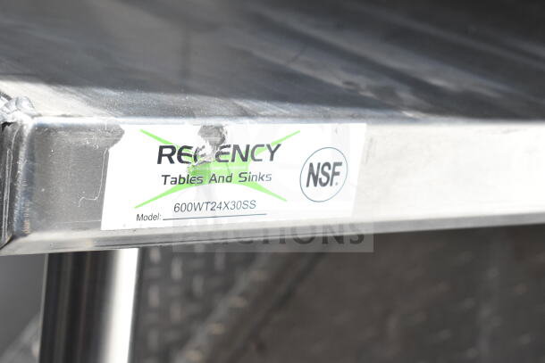 Stainless steel surface edge with "Regency Tables and Sinks" and NSF label. Model: 600WT24X30SS visible.