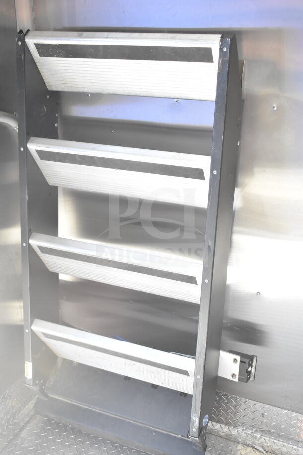 Interior view of Rock Solid Cargo 8.5'x28' food trailer shell with CaptiveAire grease hood, ready for customization.